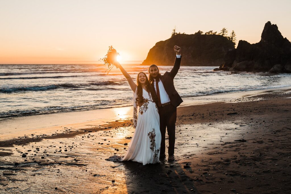 Bride and groom cheer during their sunset wedding photos at Ruby Beach
