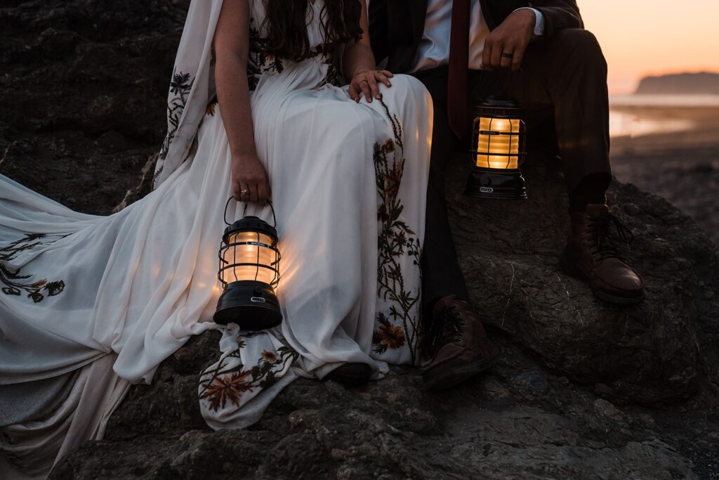 Bride and groom hold lanterns during their sunset wedding photos on Ruby Beach