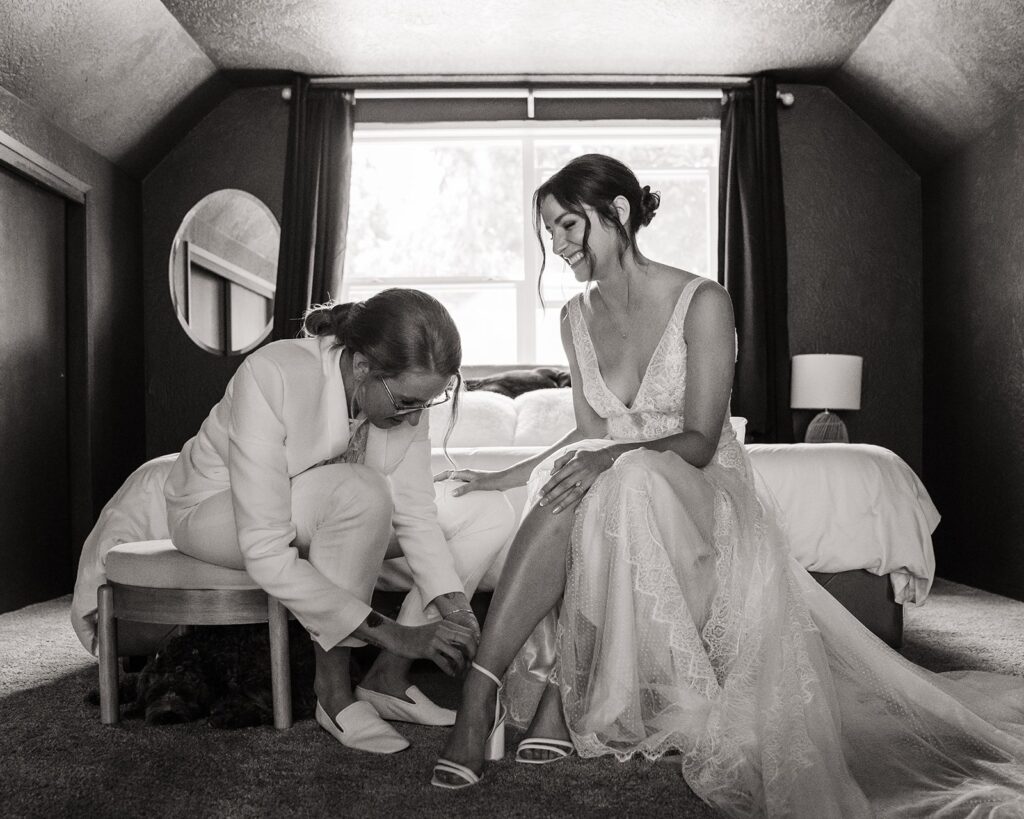 Brides helping each other get ready for their Olympic National Park wedding