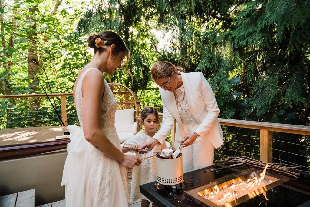 Brides roast homemade marshmallows at Olympic National Park wedding reception
