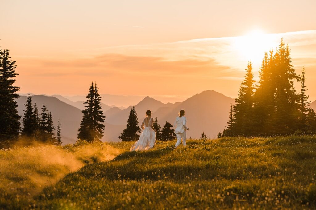Brides run through the field during their sunset wedding photos in Olympic National Park 
