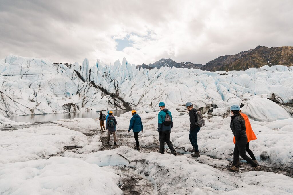 Group trekking across Alaska glaciers during elopement in Alaska
