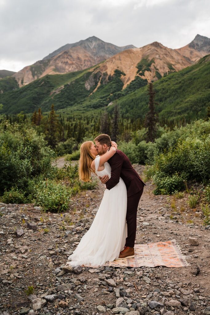 Bride and groom kiss during Alaska elopement ceremony