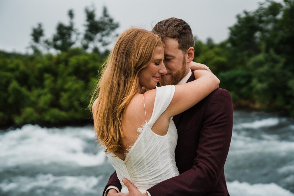 Bride and groom hug during elopement photos in Alaska