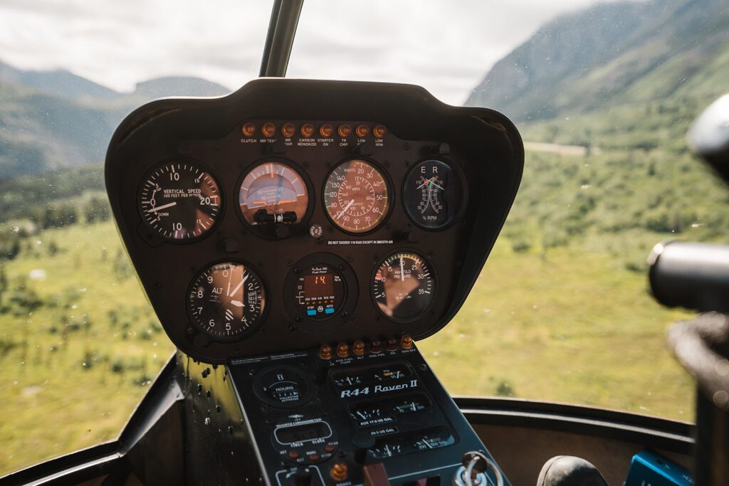 Helicopter control panel while flying over the mountains in Alaska