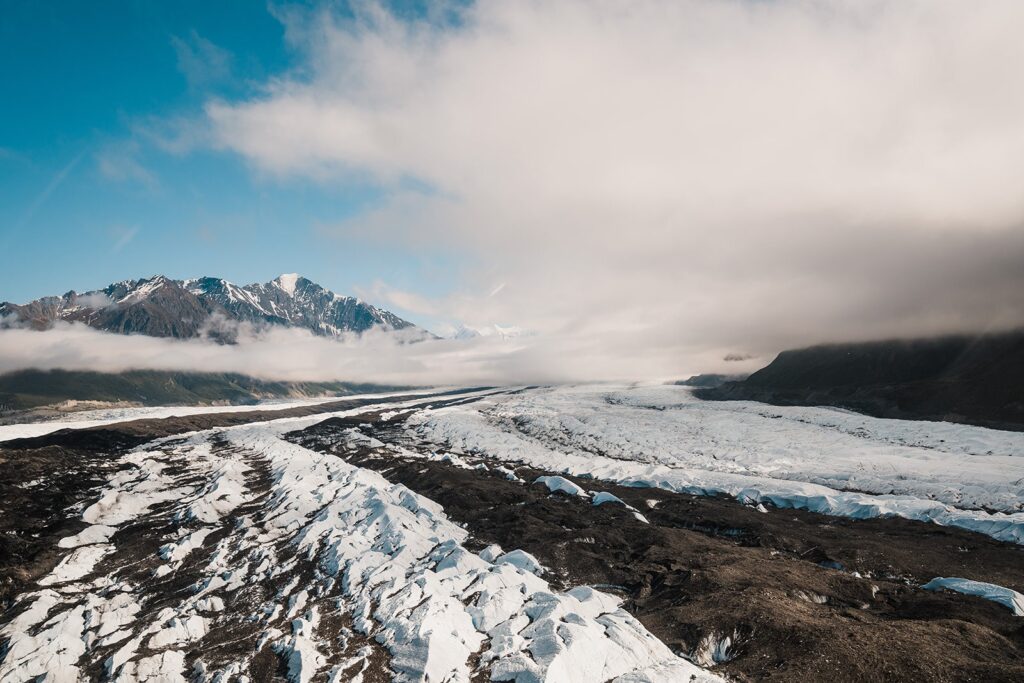 Snow-covered Alaskan mountains and glaciers during helicopter tour