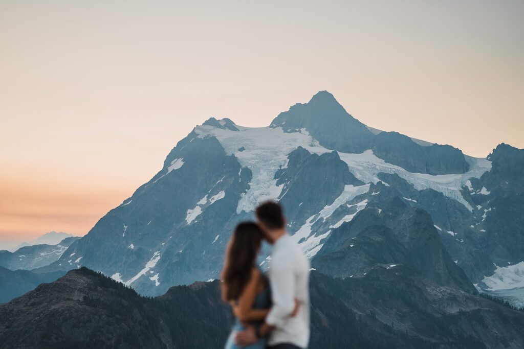 Bride and groom hug while looking out at the mountain during their Artist Point sunrise elopement photos