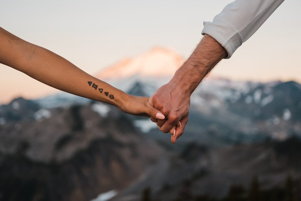Bride and groom hold hands during their sunrise elopement photos at Artist Point