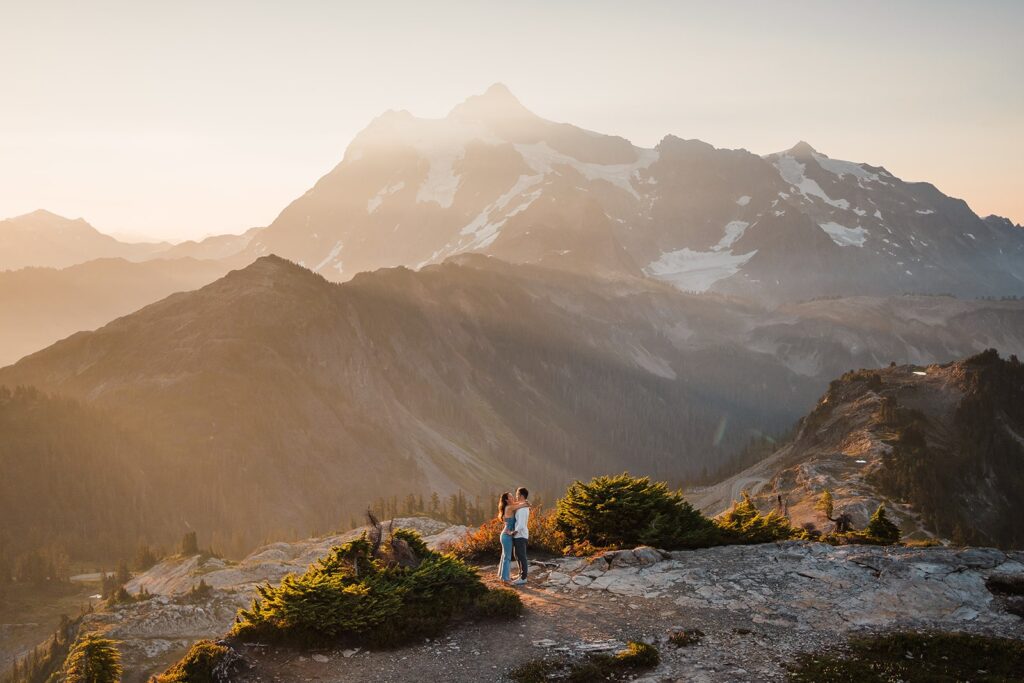 Bride and groom hug on a hiking trail at Artist Point during their sunrise elopement photos