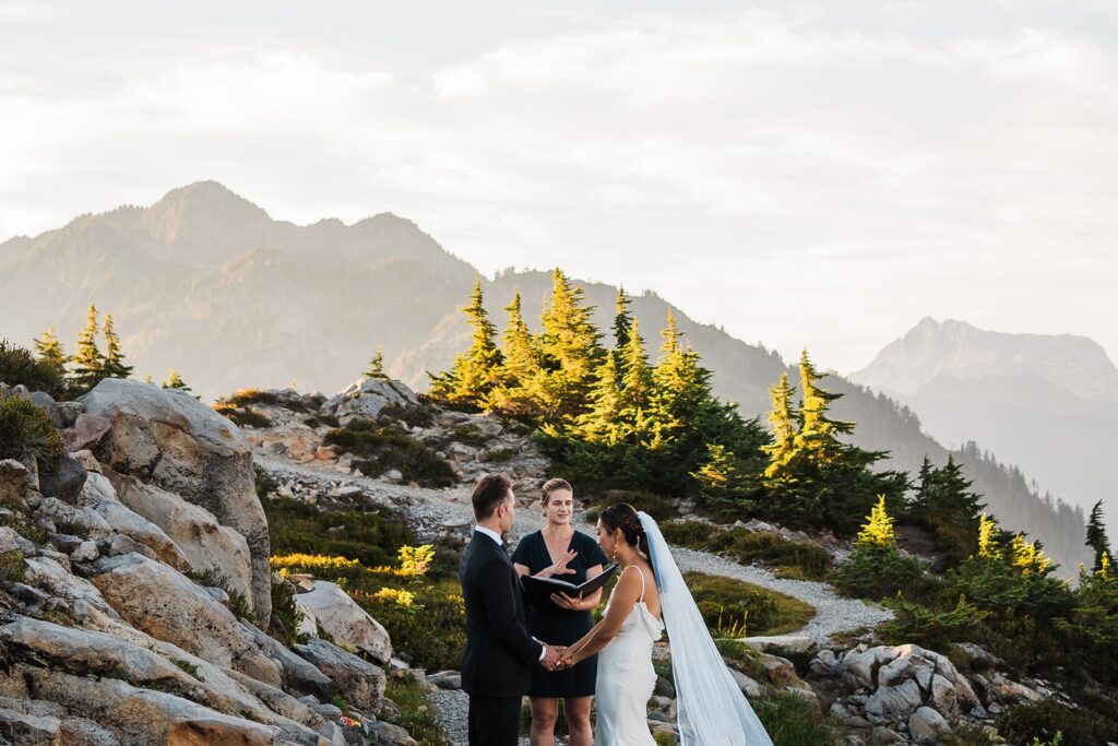 Bride and groom exchange vows on a hiking trail during their North Cascades elopement