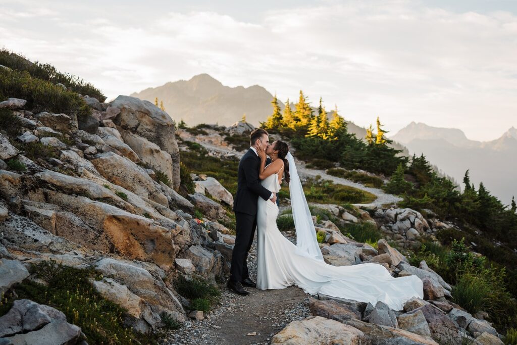 Bride and groom kiss on a hiking trail during their Artist Point elopement