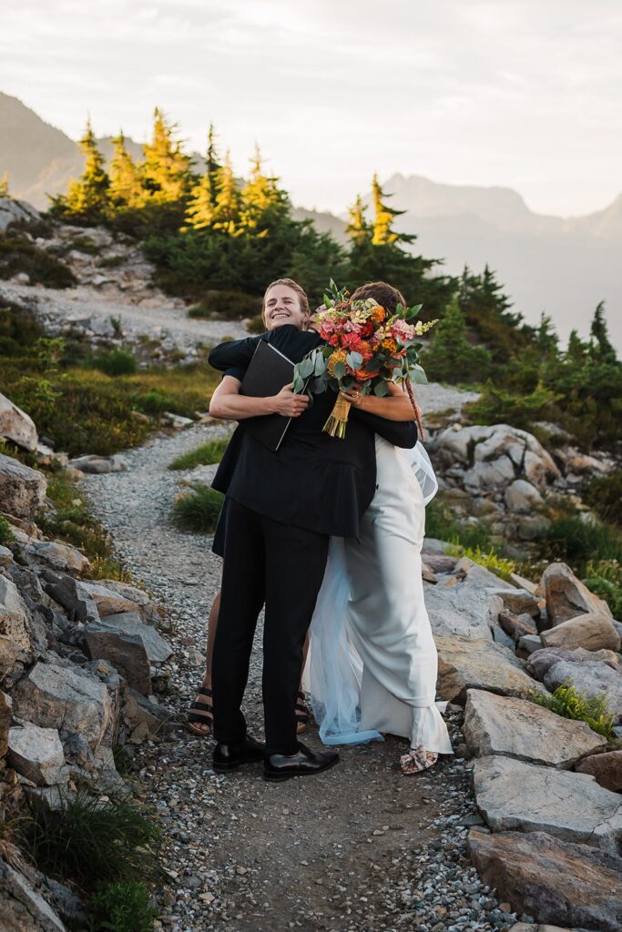 Bride and groom hug officiant after their Artist Point elopement ceremony