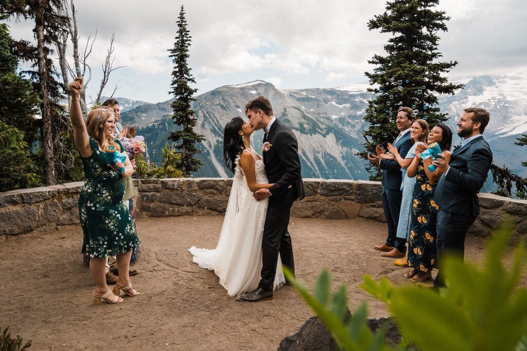 Bride and groom kiss at their Mount Rainier National Park wedding ceremony