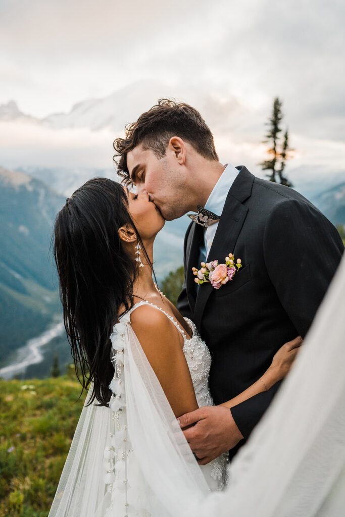 Bride and groom kiss during their sunset photos at Mount Rainier National Park