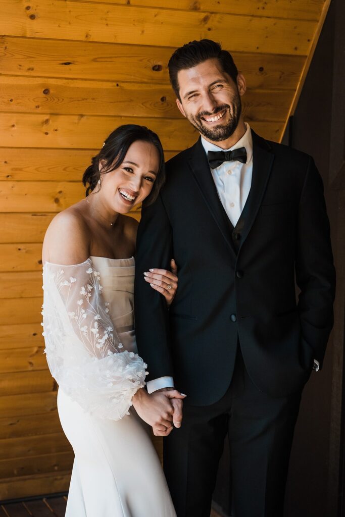 Bride and groom smile during their first look photos at an elopement cabin in Washington