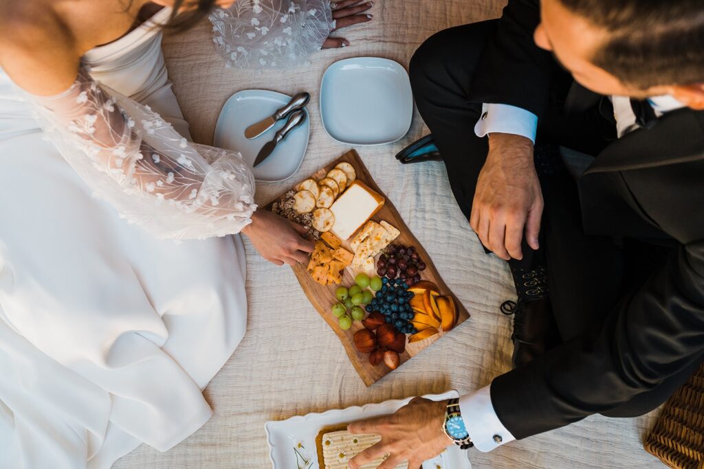 Bride and groom share a picnic lunch at their Airbnb cabin in Washington