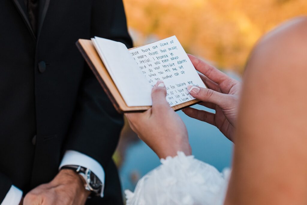 Bride reads handwritten vows during her alpine lake elopement ceremony in Washington