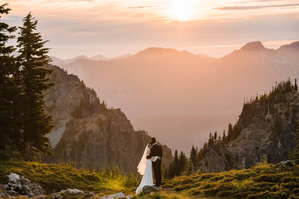 Bride and groom hug during their sunset photos at Mount Rainier National Park