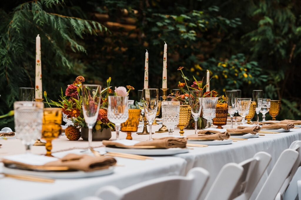 Autumn toned wedding reception decorations in the forest 