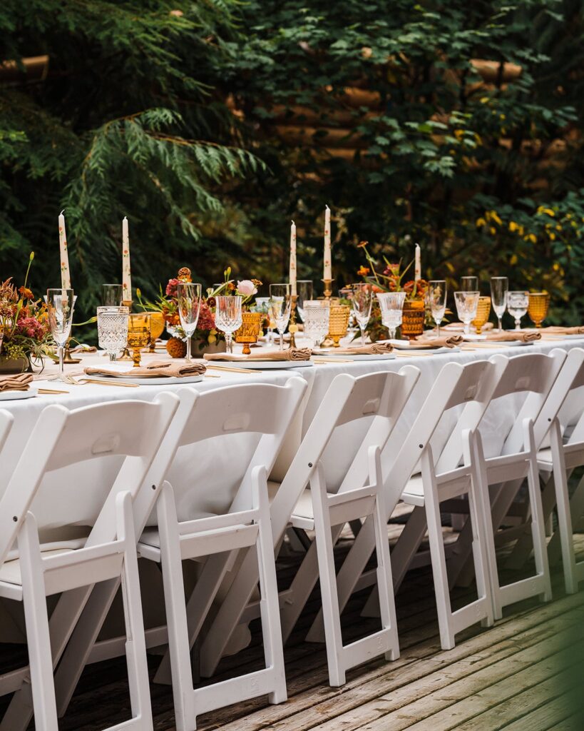 Autumn toned wedding reception decorations in the forest 