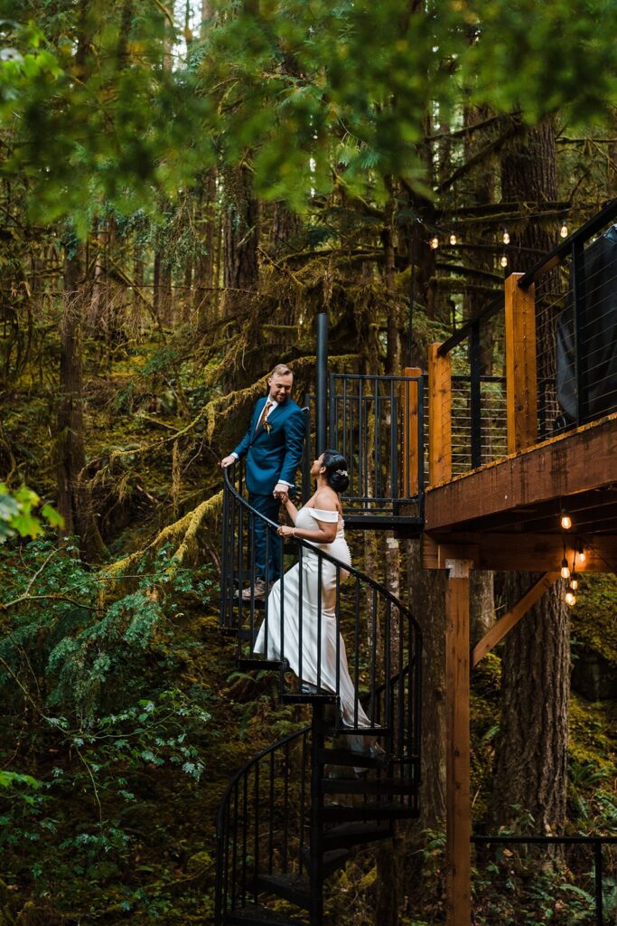 Bride and groom walk up the black iron steps at Mt Baker Hygge Haus