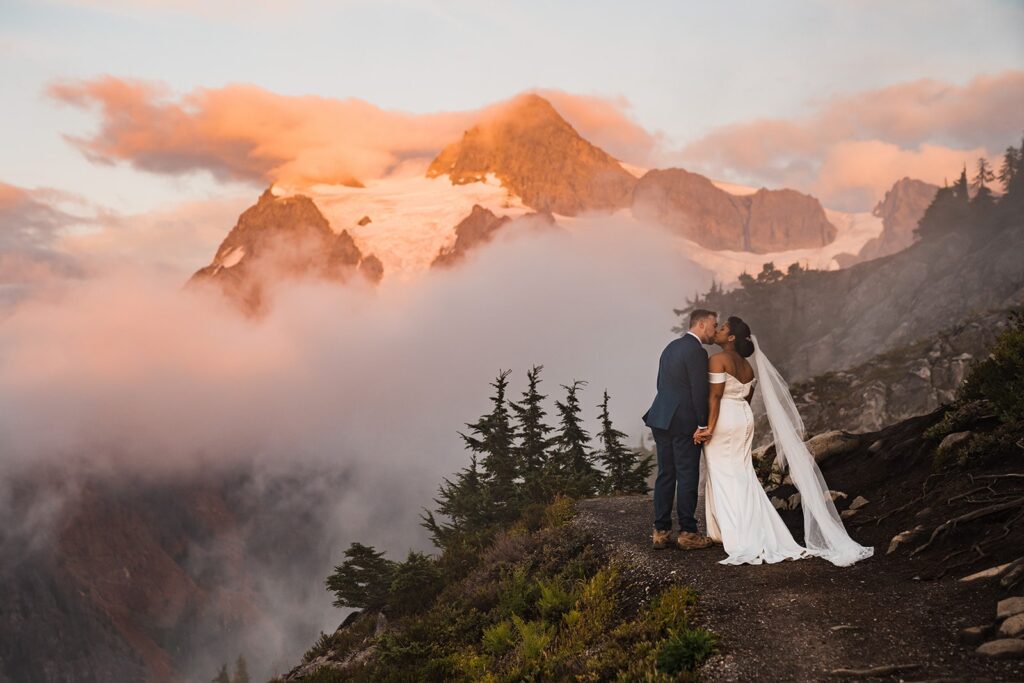 Bride and groom kiss during their sunset elopement photos in the North Cascade mountains