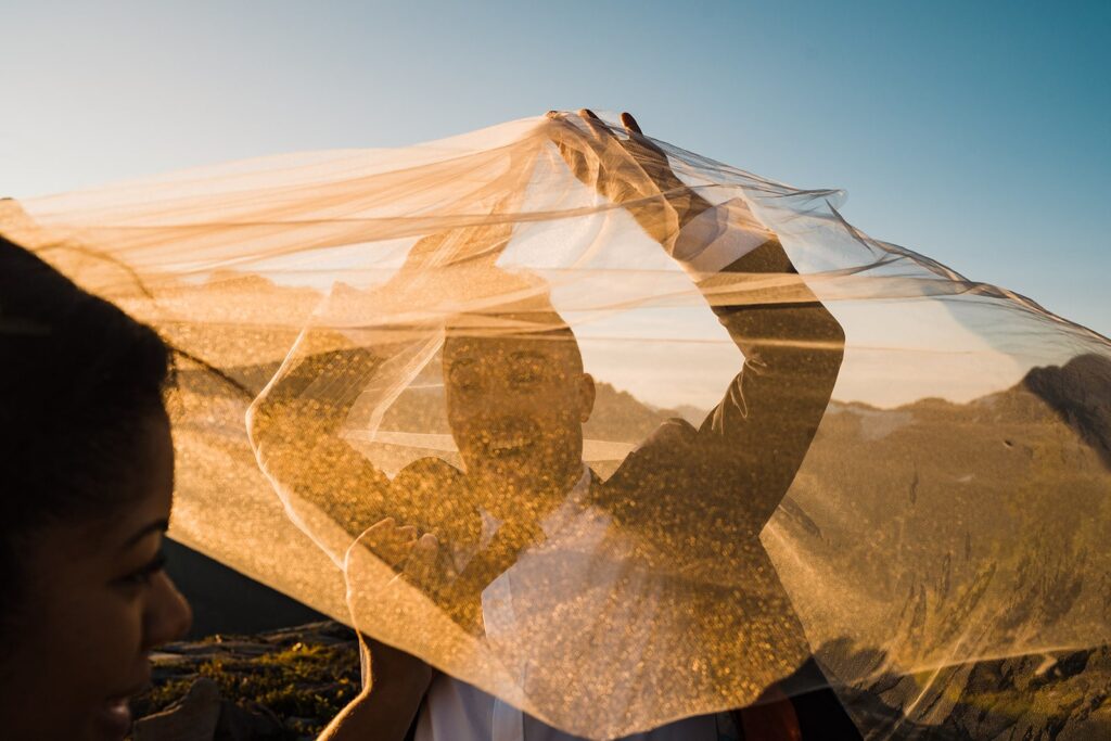 Broom plays with veil during sunrise elopement photos at Artist Point