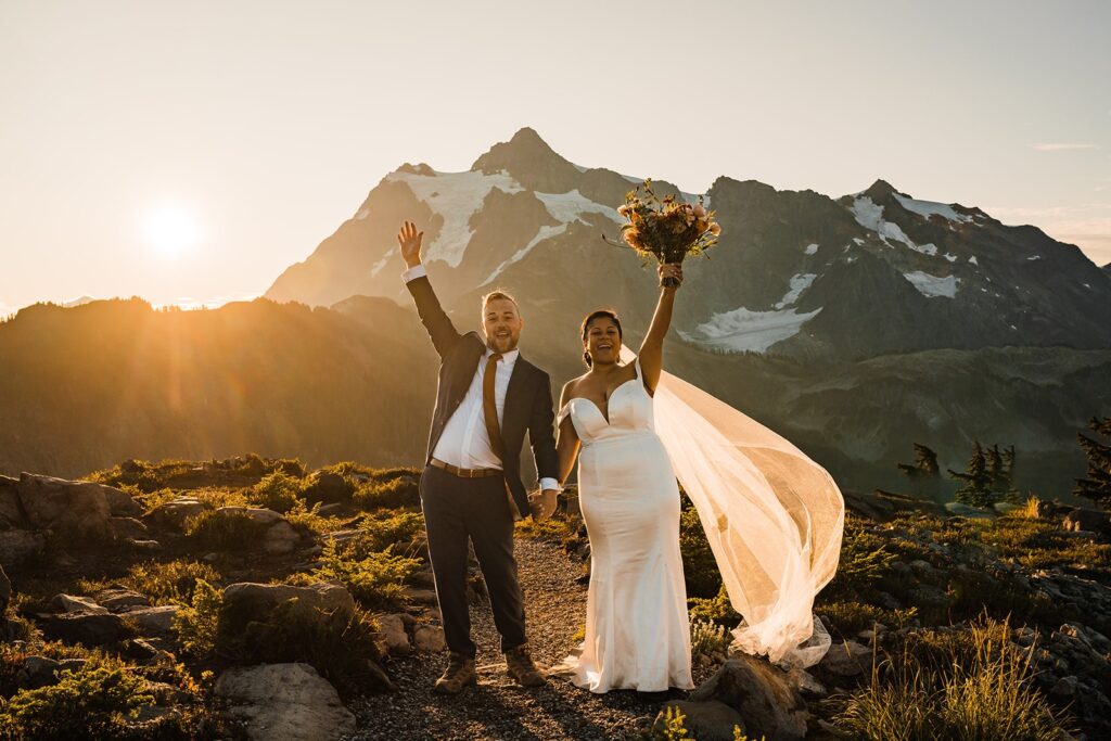Bride and groom cheer during their sunrise elopement photos at Artist Point