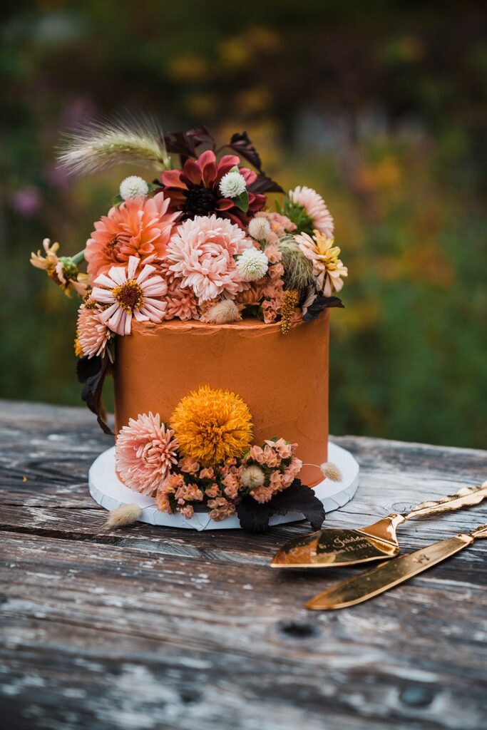 Burnt orange wedding cake with fresh flowers