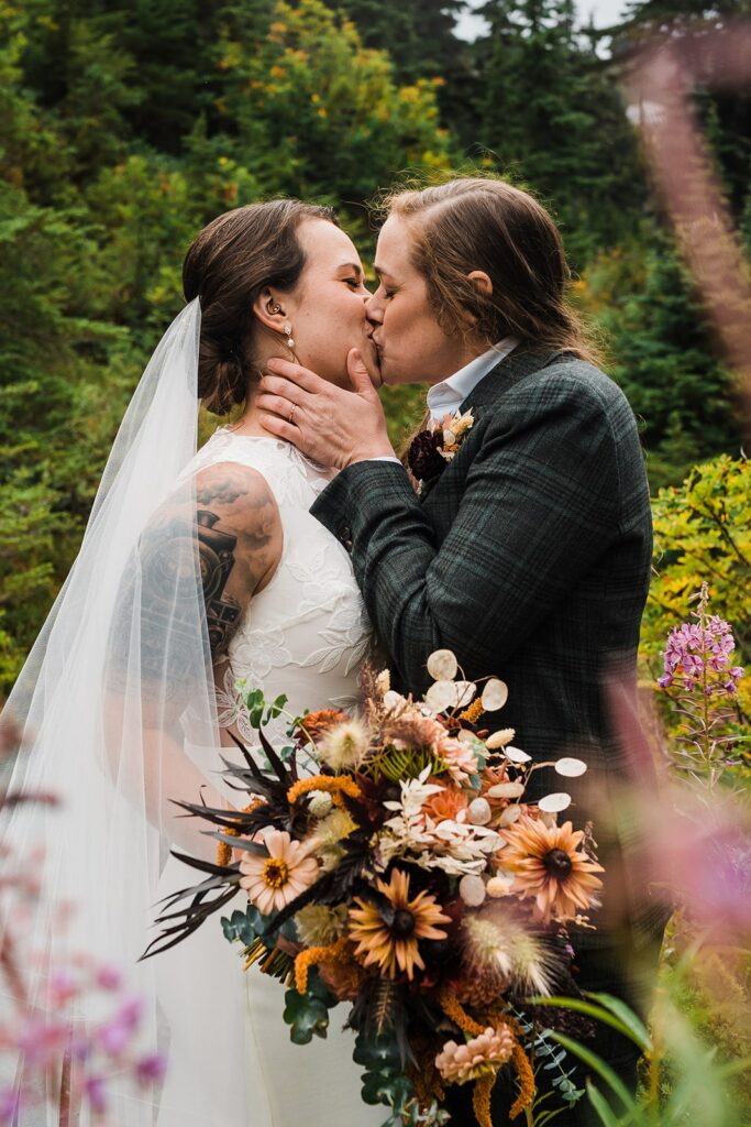Brides kiss during their North Cascades wedding photos