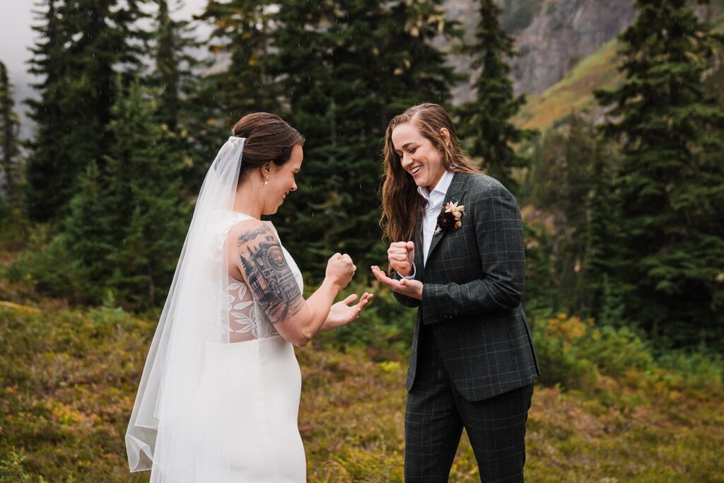 Brides play rock, paper, scissors in the North Cascades