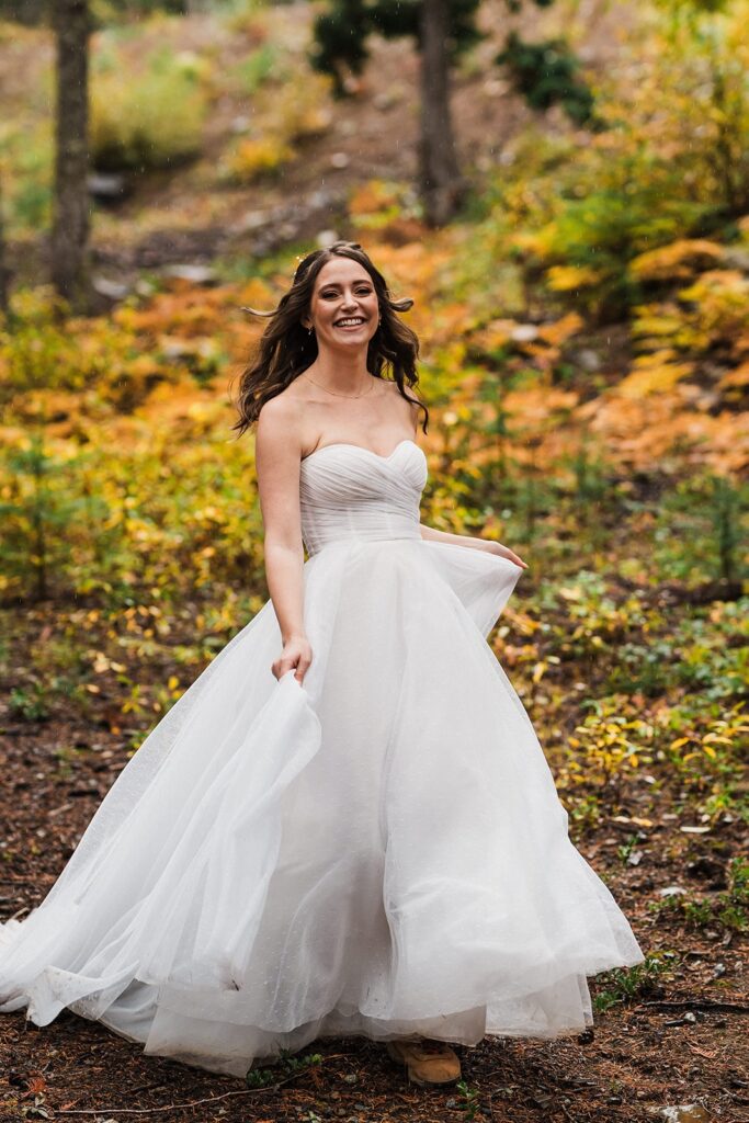 Bride runs along a forest trail during her elopement in Snoqualmie