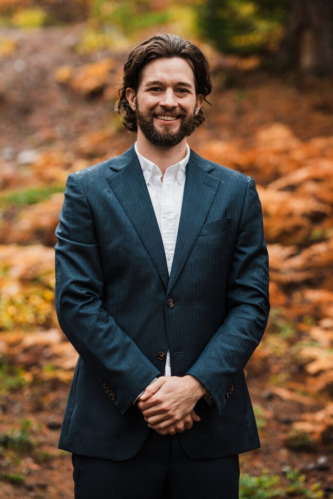 Groom wearing a blue suit for his portrait photos in Snoqualmie