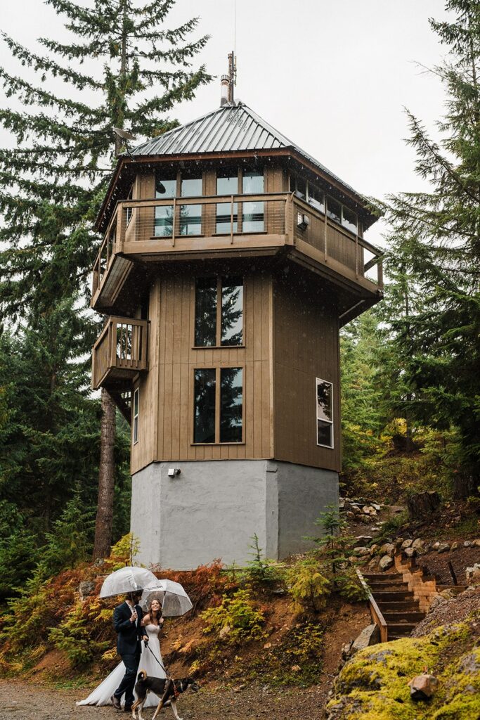 Bride and groom walk toward their fire lookout airbnb in Snoqualmie, Washington