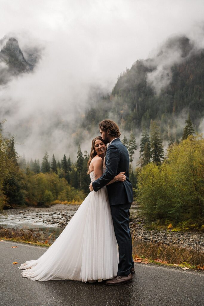 Bride and groom hug during their forest elopement photos in Snoqualmie