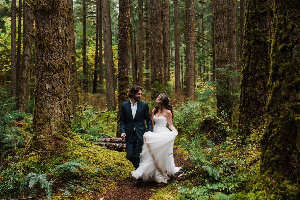 Bride and groom walk through the forest during their elopement in Snoqualmie 