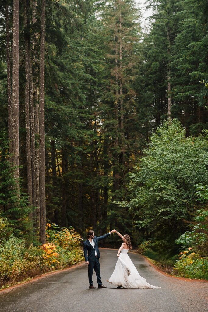 Bride and groom dance on a forest road in Snoqualmie 