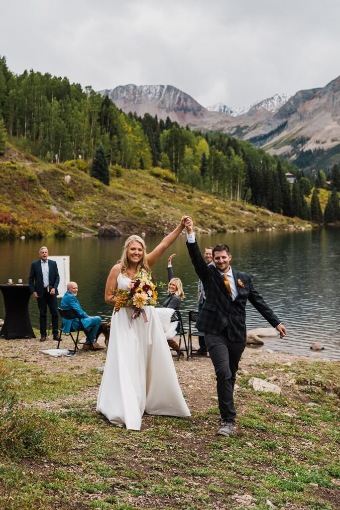 Bride and groom cheer as they exit their outdoor elopement ceremony in Telluride