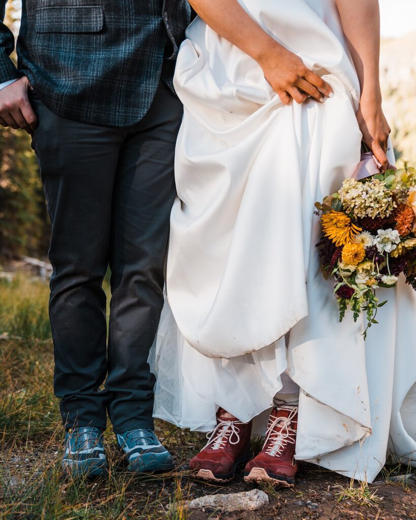Bride and groom wear hiking boots with their wedding attire