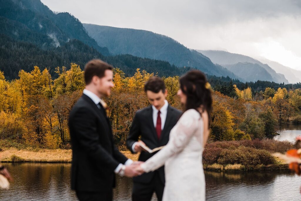Bride and groom hold hands during their Columbia River Gorge wedding