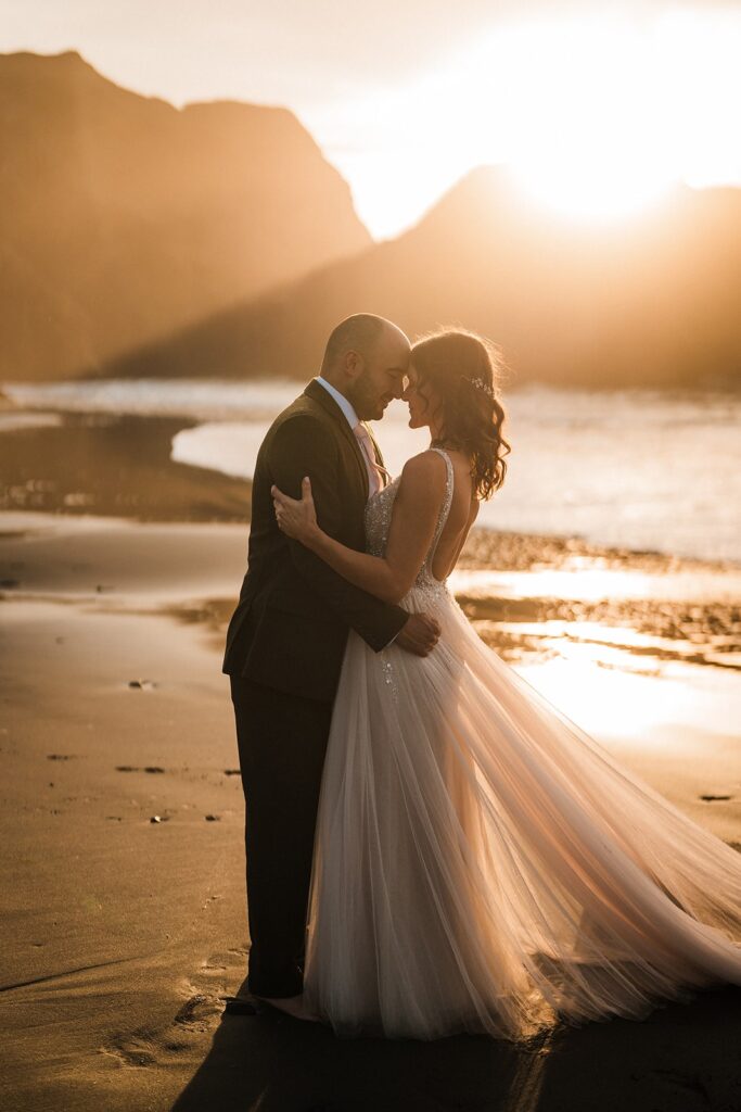 Bride and groom hug during their elopement on the Oregon Coast at sunset