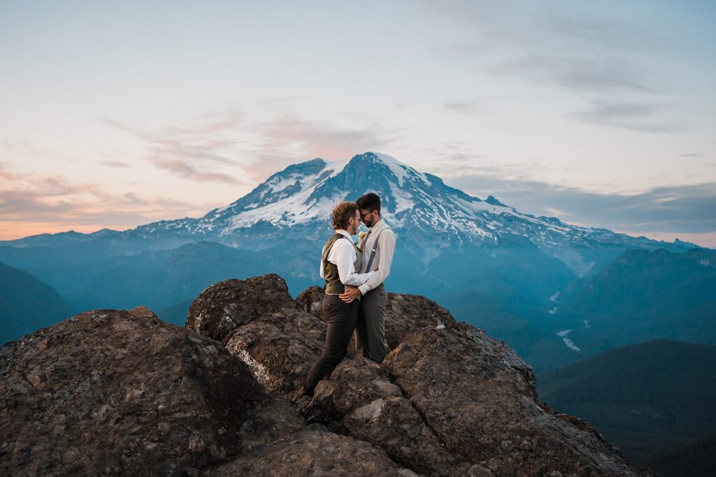 Two grooms hug during their Mt Rainier elopement