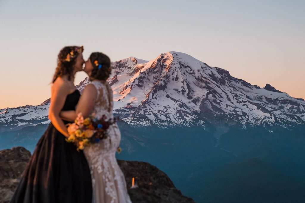 Brides kiss in front of Mt Rainier at sunset