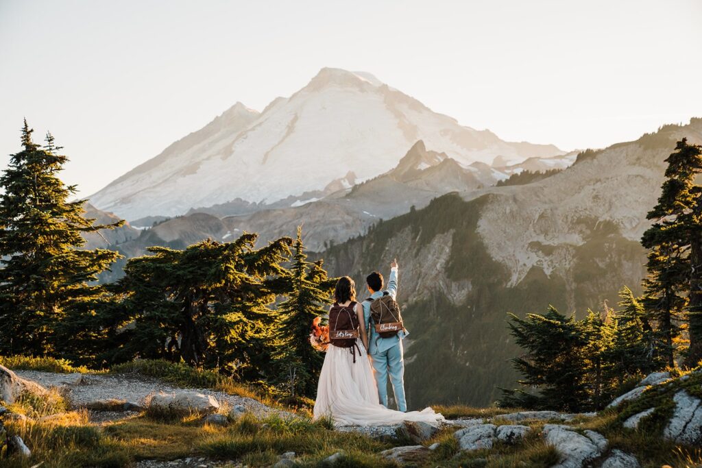 Bride and groom wearing hiking backpacks during their North Cascades National Park elopement