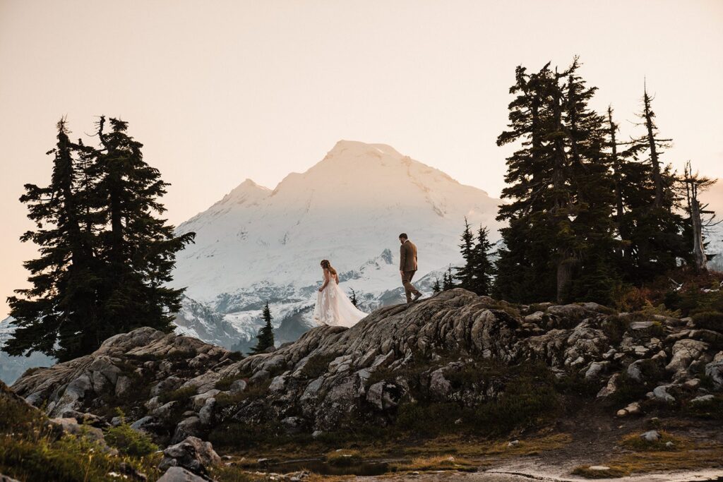 Bride and groom walk down a hiking trail during their elopement in the North Cascades