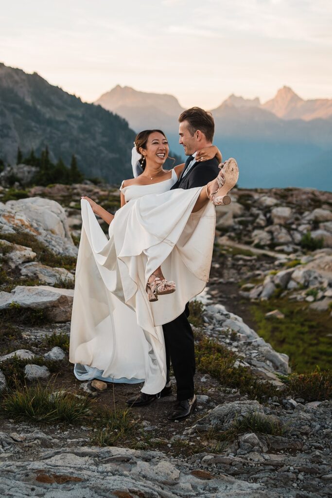 Groom swings bride around during their elopement in the North Cascades