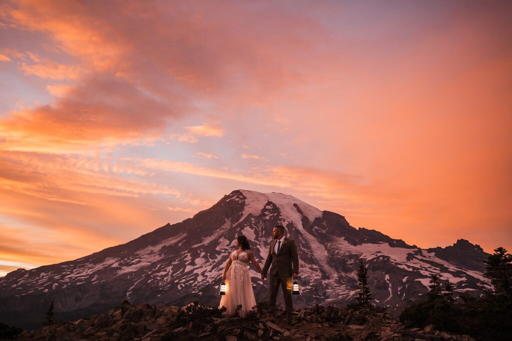 Bride and groom hold lanterns during their Mt Rainier National Park sunset elopement photos
