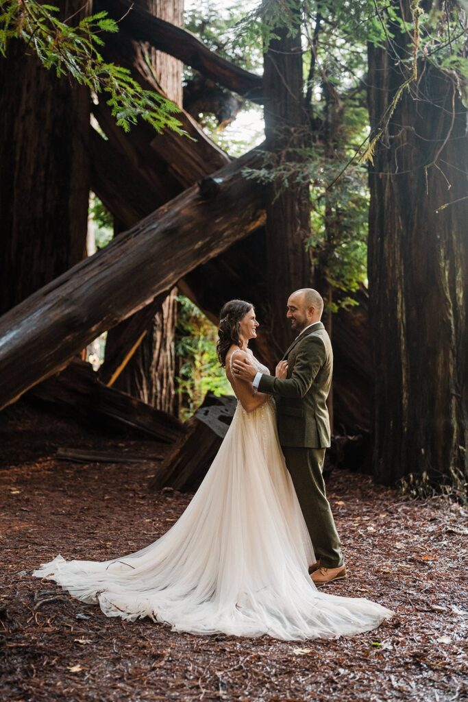 Bride and groom hug for elopement photos at Redwood National Park