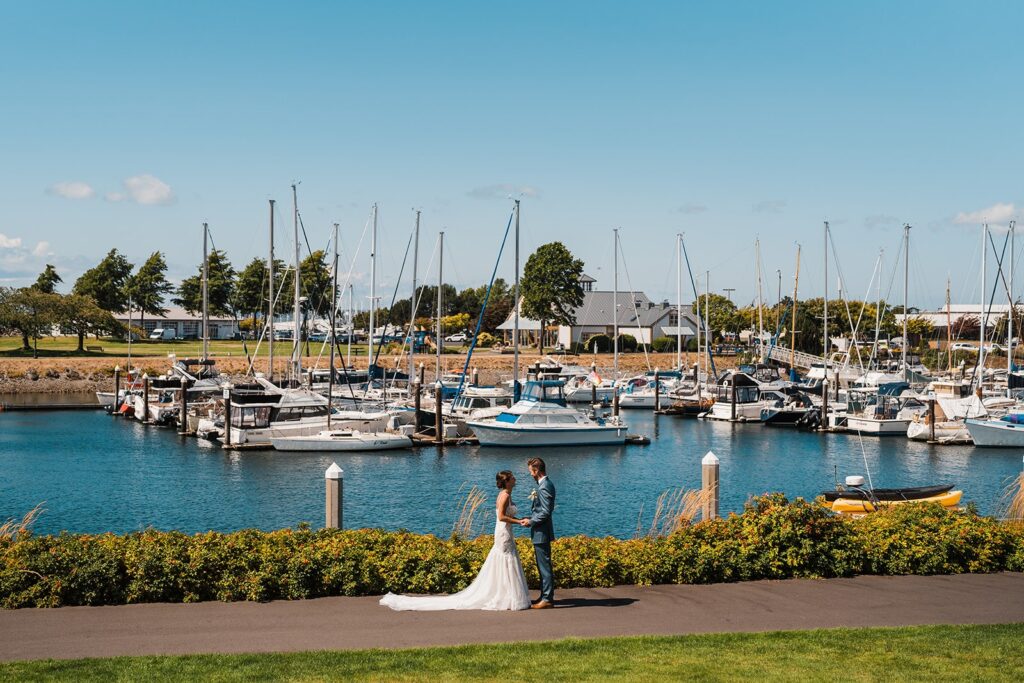 Bride and groom hold hands by the bay after their Washington micro wedding first look