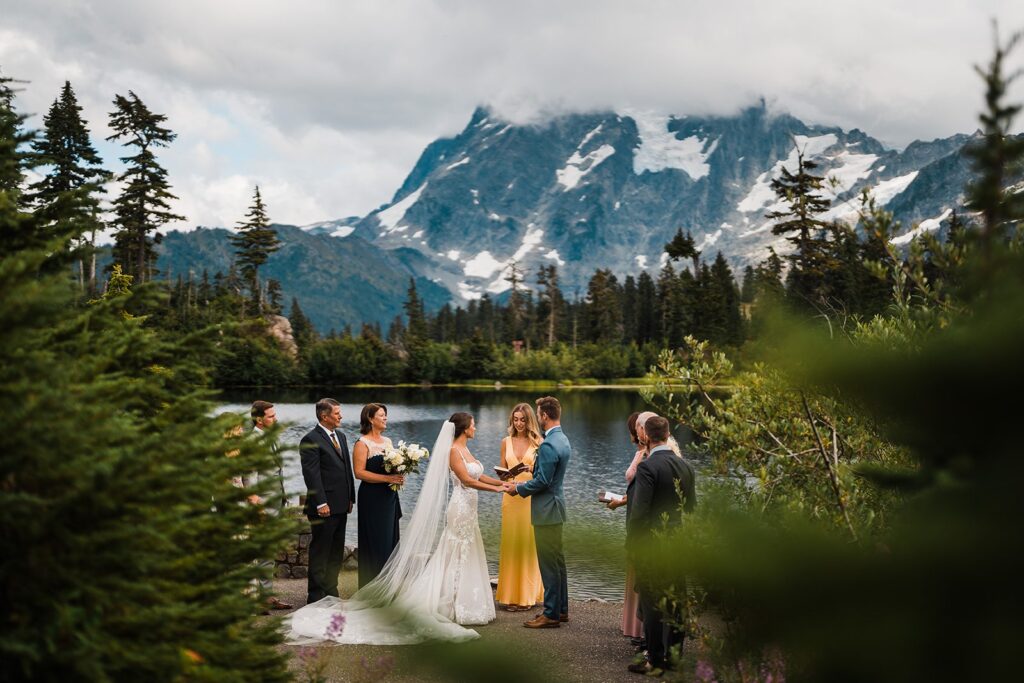 Bride and groom hold hands during their Washington micro wedding ceremony at Picture Lake